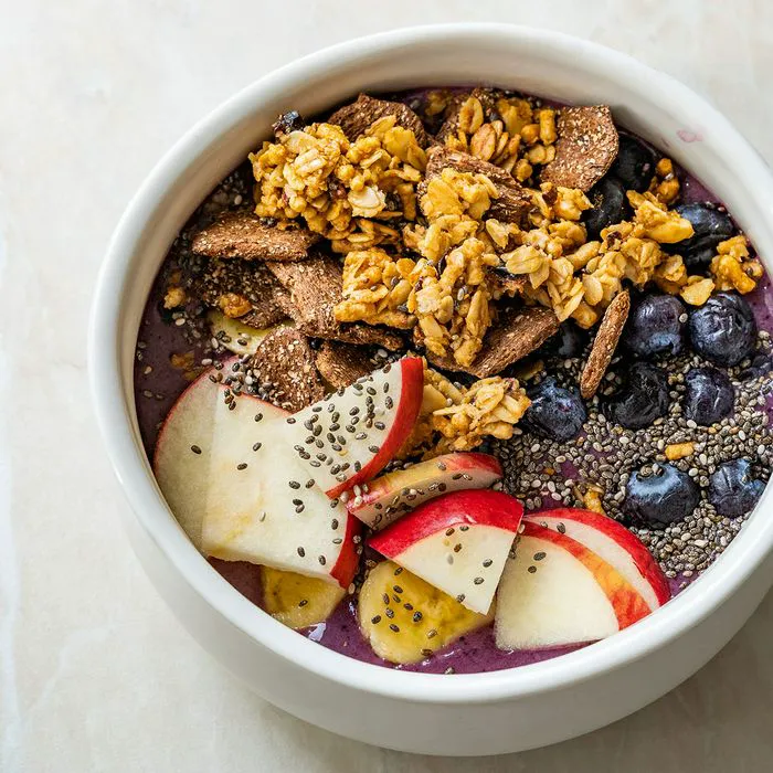 smoothie bowl topped with chia seeds and apples