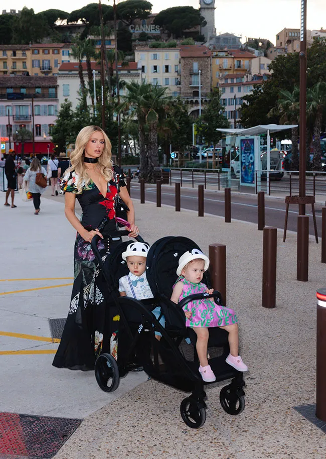 Paris Hilton walks her babies in Cannes wearing a floral dress