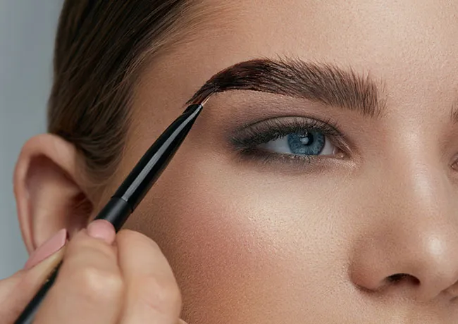 woman-applying-eyebrow-makeup