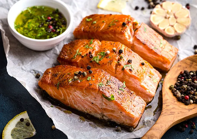 Grilled salmon drizzled with olive oil and herbs