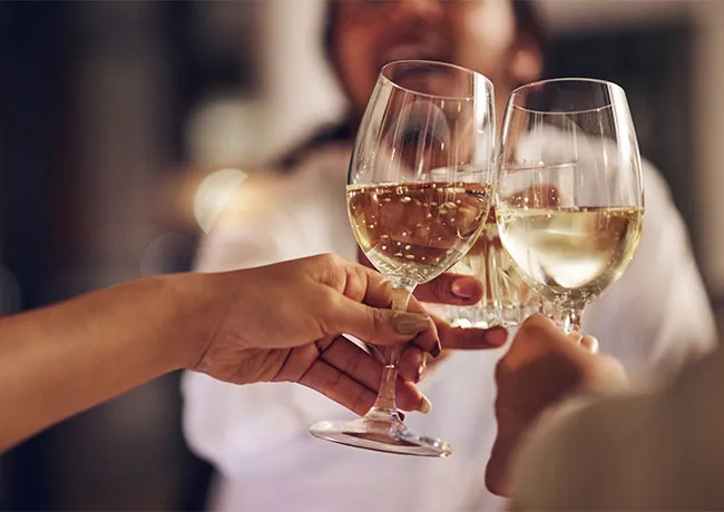 Friends cheering with wine glasses in celebration