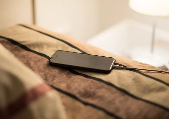 iphone-charging-on-bed