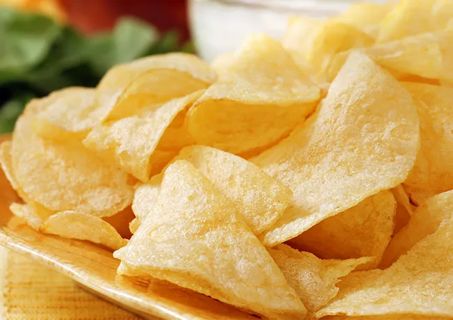 Crispy potato chips in a serving bowl