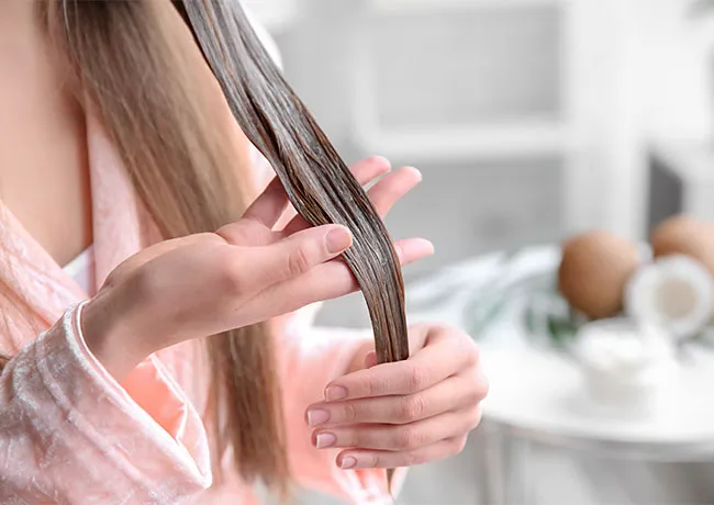 woman-applying-coconut-oil-hair