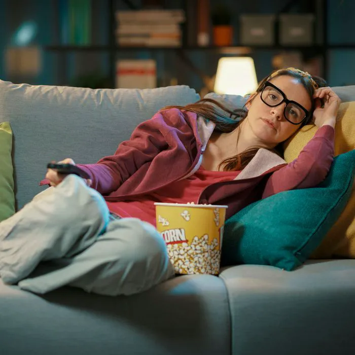 woman on couch with popcorn