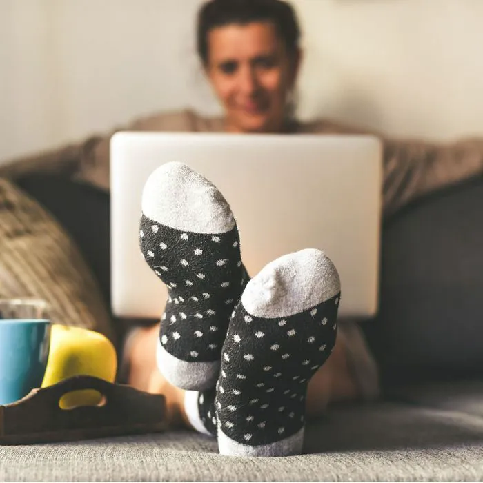 woman on couch on laptop