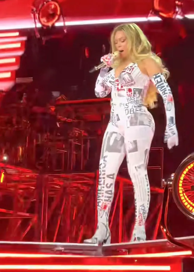 Beyoncé walks on stage in a newspaper print bodysuit.