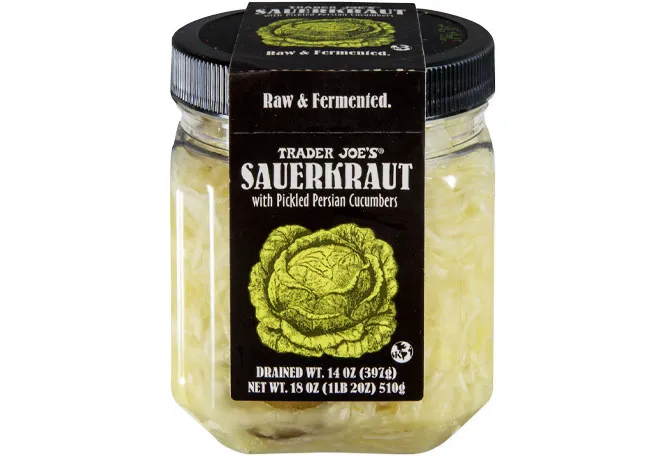 Jar of Trader Joe's sauerkraut with fresh vegetables.