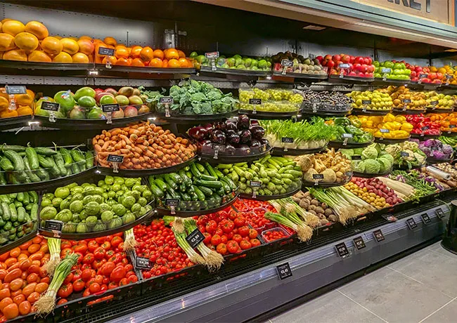 Fresh produce section in a grocery store with colorful fruits and vegetables.