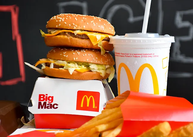 Two McDonald's cheeseburgers displayed on a box.