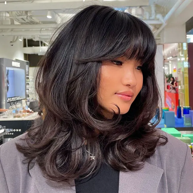 Young woman sporting a trendy fairy haircut.