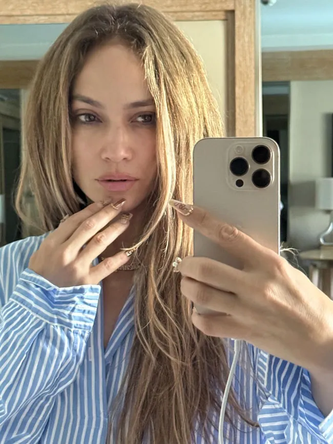 Jennifer Lopez's natural beauty in a mirror selfie without makeup.