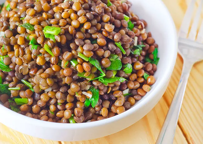 Colorful cooked lentil salad with vegetables
