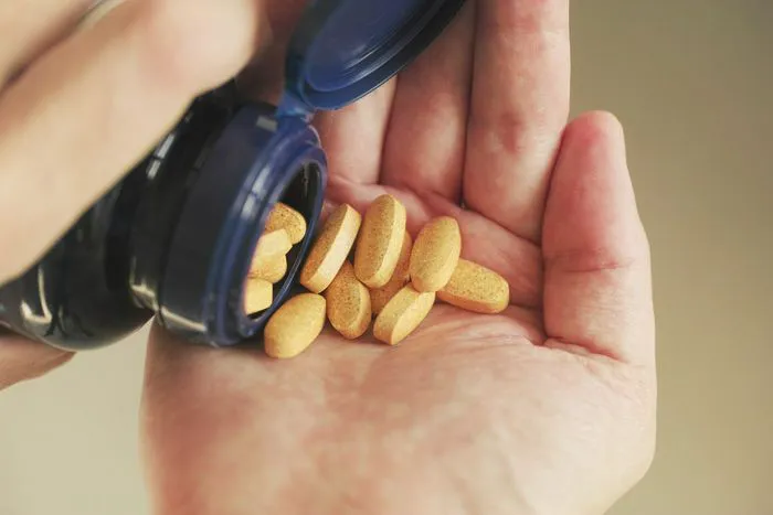 "Handful of supplements ready to be taken"