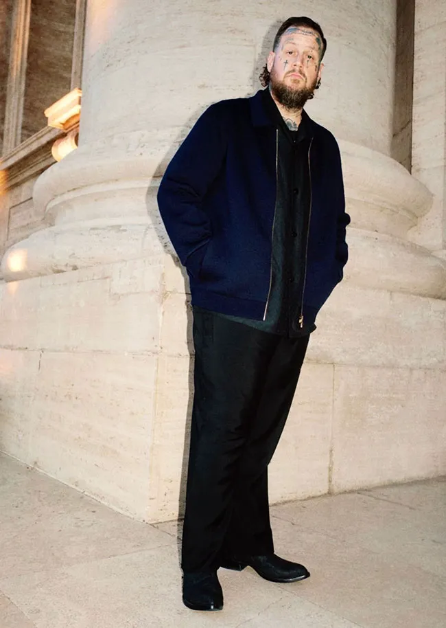 Jelly Roll showcasing Louis Vuitton fashion in a stylish look.