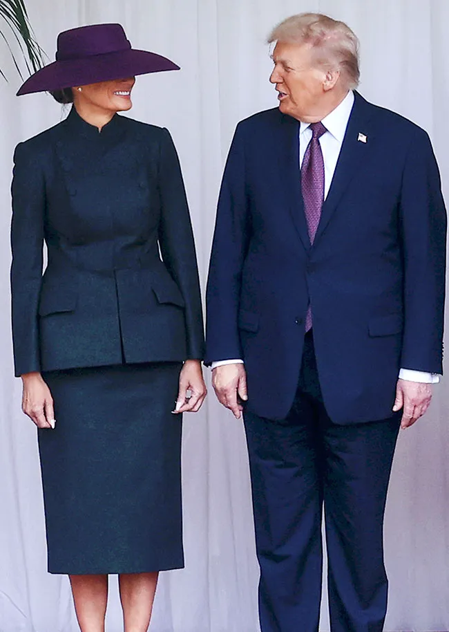 "Melania Trump wearing a purple wide-brimmed hat"