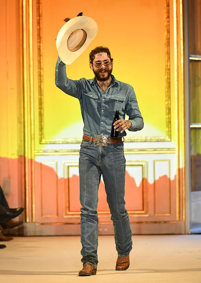 Post Malone performing at Paris Fashion Week on stage.