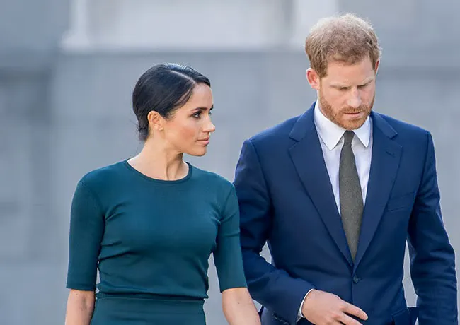 Prince Harry and Meghan Markle both wearing blue