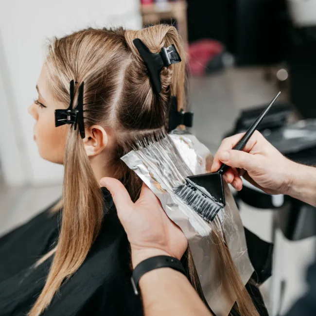 "Close-up of a person using hair dye"