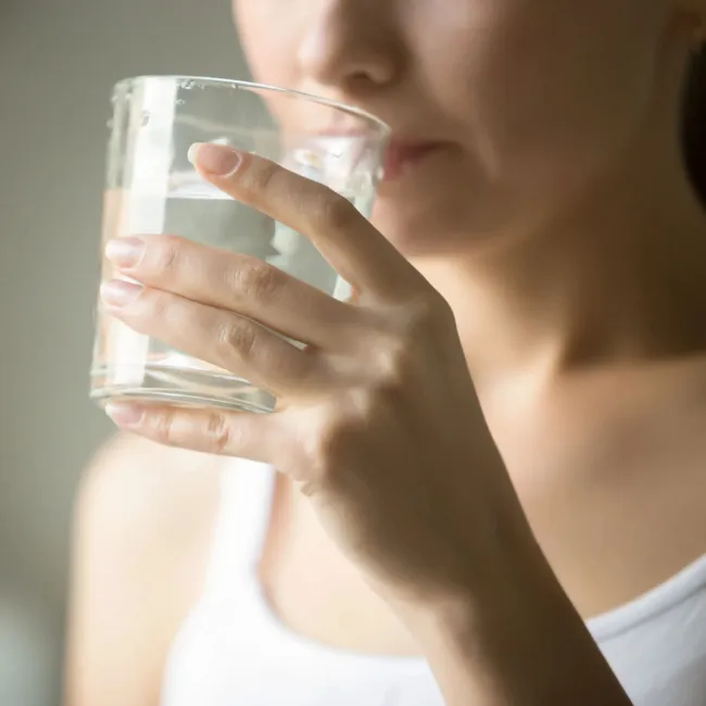Woman enjoying a glass of water.