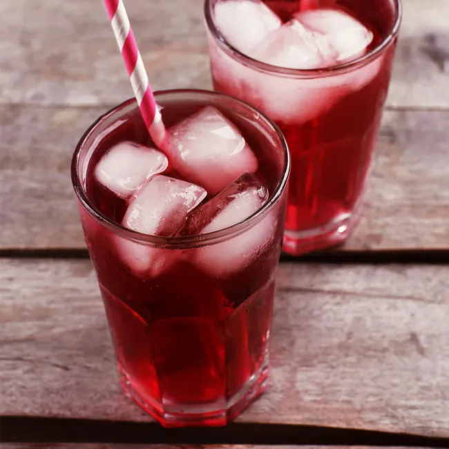 Refreshing red iced cherry juice in glasses.