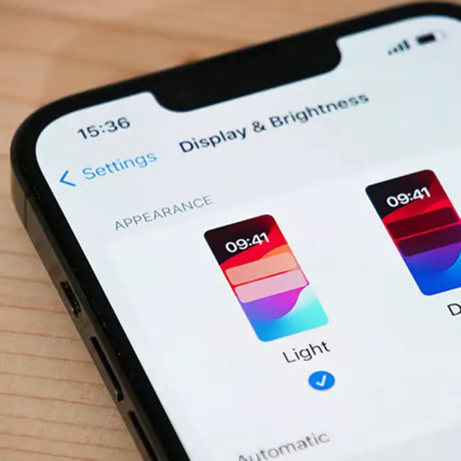 "iPhone screen brightness settings on a smartphone"