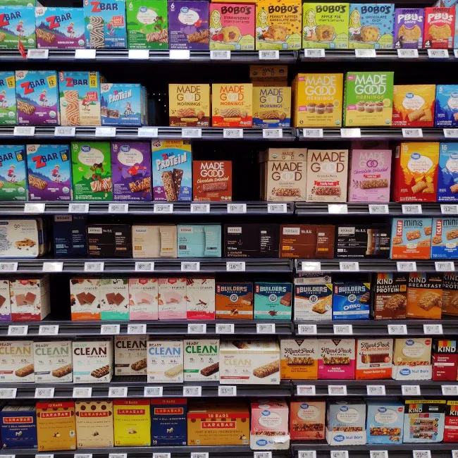 Granola bars displayed on a grocery store shelf.