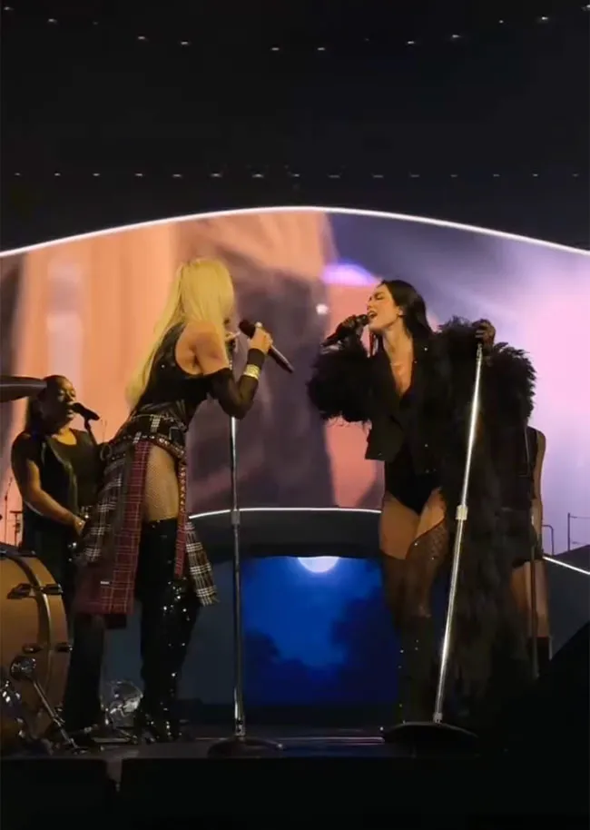 Gwen Stefani and Dua Lipa performing together on stage.