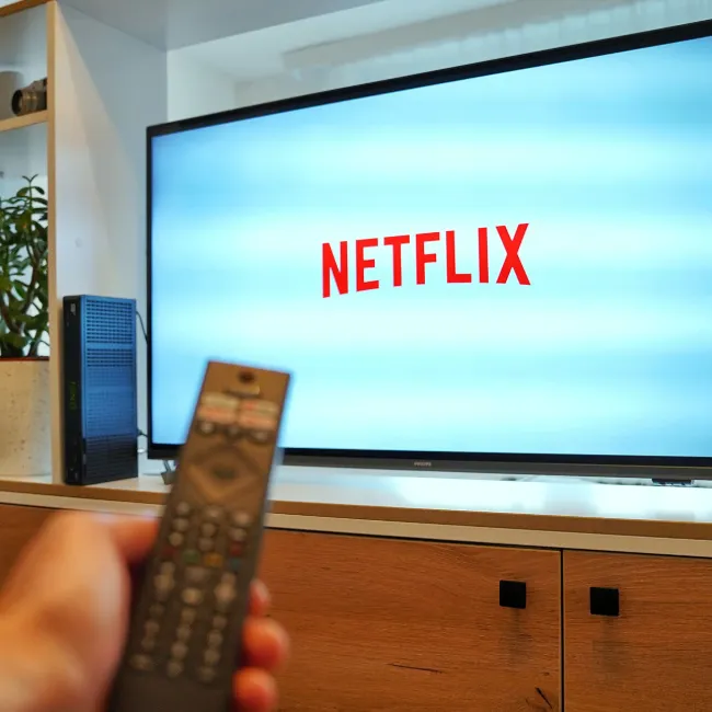 Netflix logo displayed on TV screen with remote control