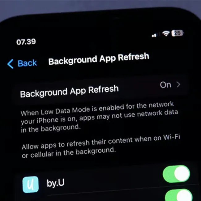 "iPhone background app refresh settings on a smartphone"