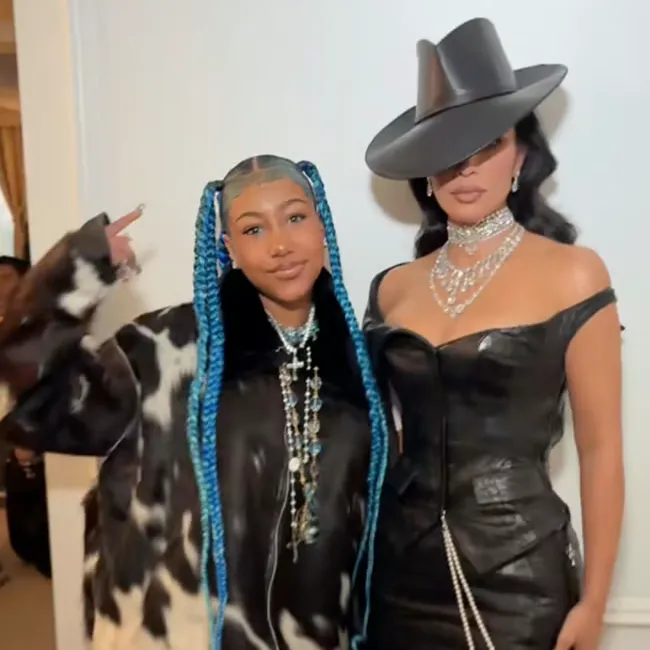 "North West with blue hair posing with Kim Kardashian"