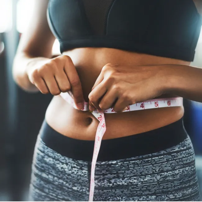 Woman eating a healthy salad after a workout