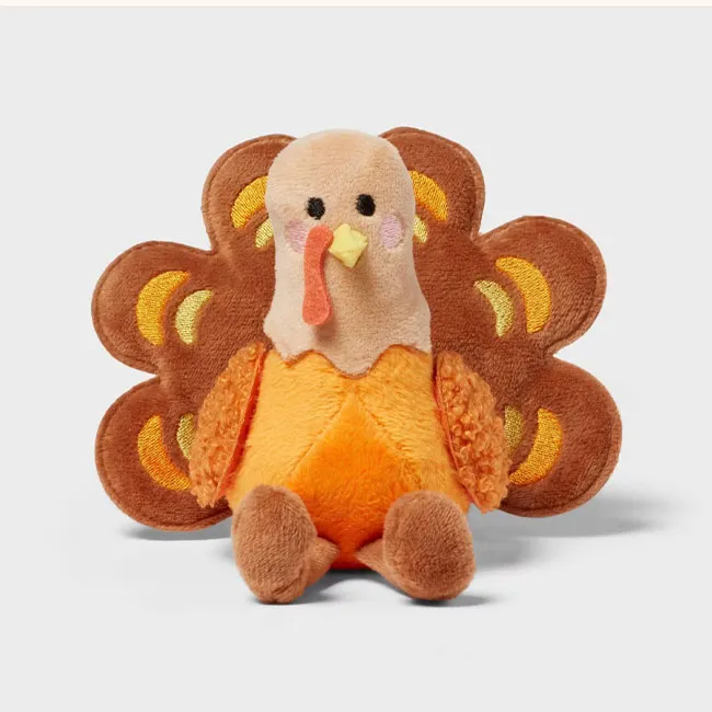 Adorable plush turkey decoration for Thanksgiving festivities.