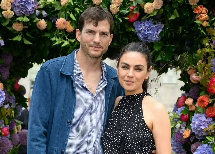 "Ashton Kutcher and Mila Kunis at an event"