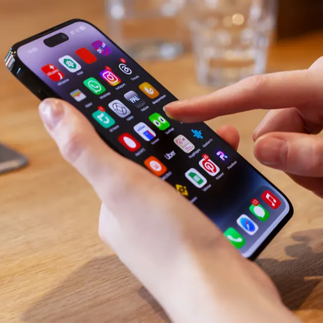 Person using various apps on an iPhone.