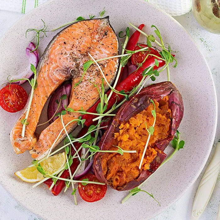Grilled salmon served with a sweet potato