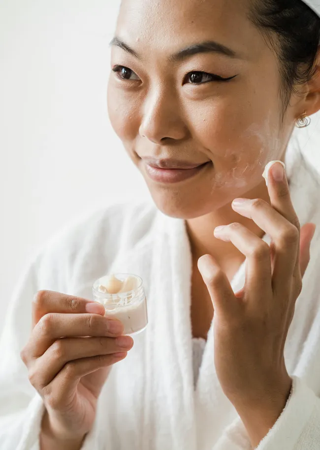 woman-moisturizing-face