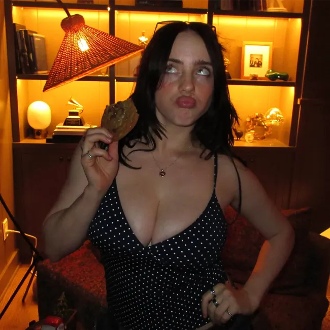 Billie Eilish posing for an Instagram photo in stylish attire.