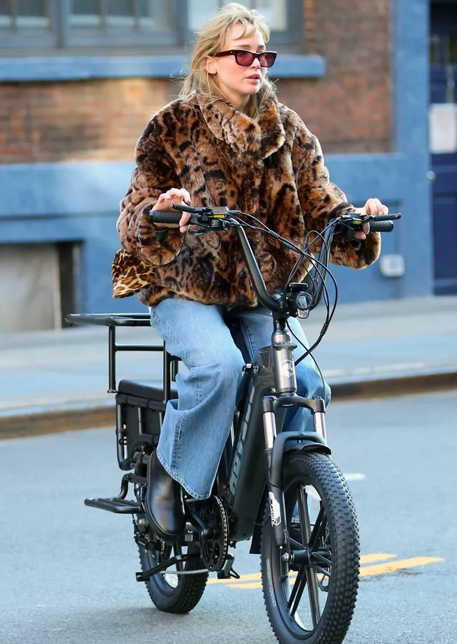 Jennifer Lawrence riding bike New York leopard coat wide leg jeans