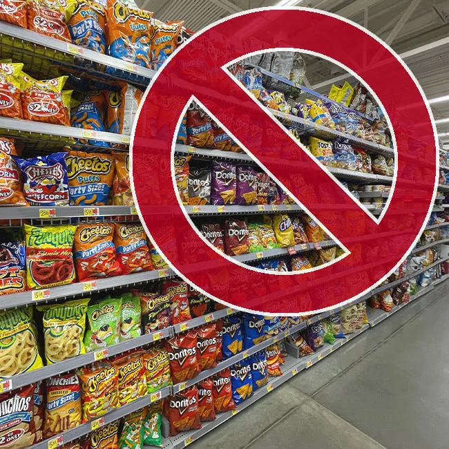 "Snack aisle in a grocery store with various products"