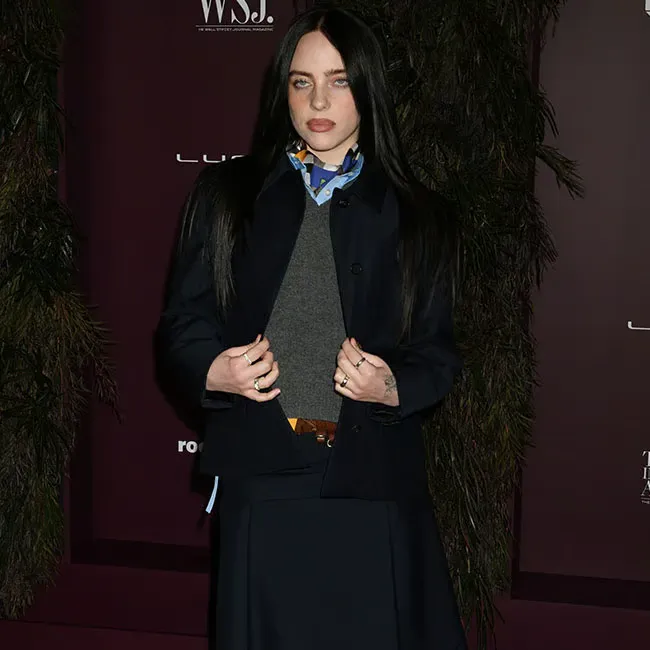 Billie Eilish showcasing her full outfit at the Innovator Awards.