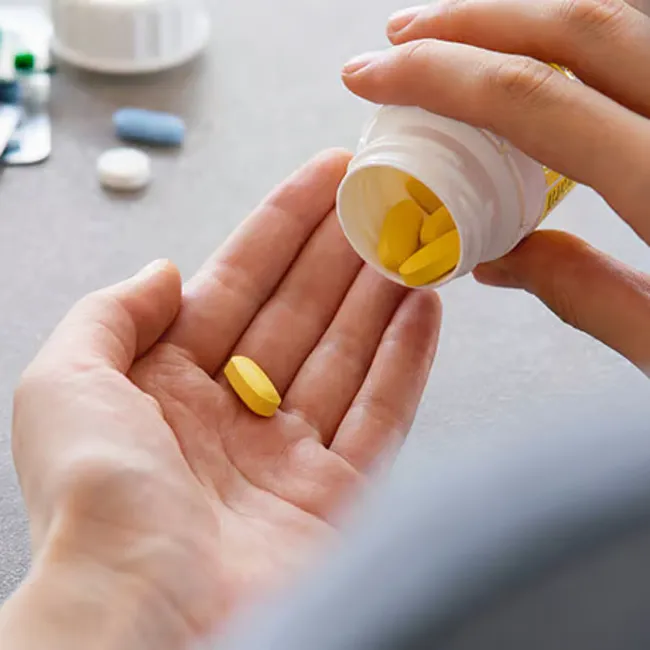 Vitamin A pill being dispensed for skincare health