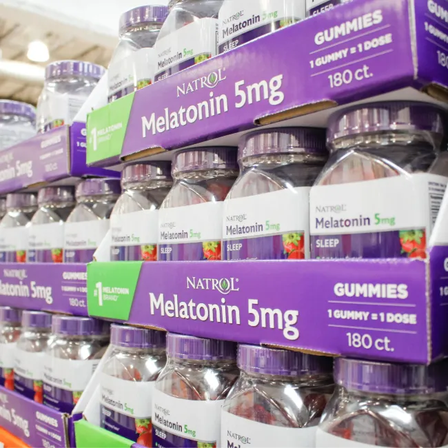 Melatonin gummies displayed on a wooden surface.