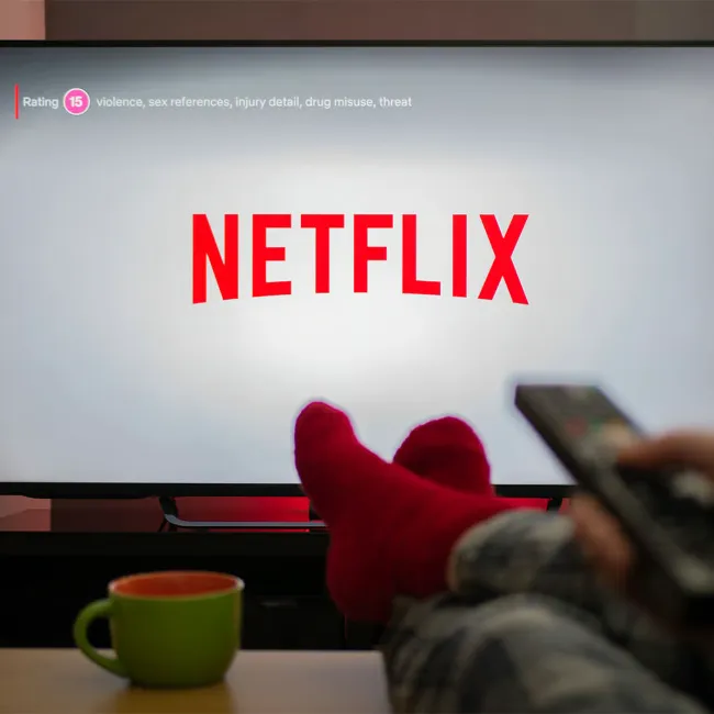 Person watching Netflix movies on a couch