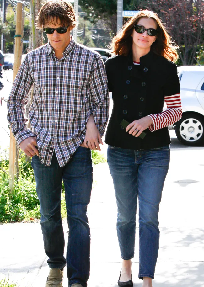 Julia Roberts and Danny Moder smile together at a public event.