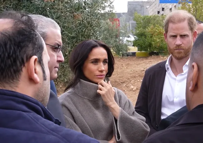 Harry and Meghan in turtleneck sweaters at Jordan refugee camp.