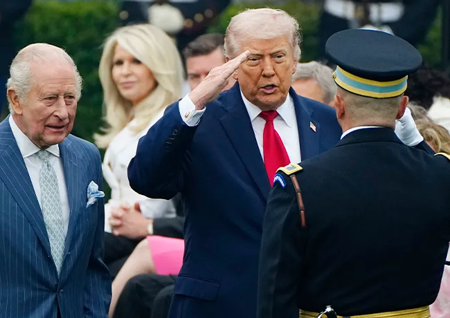Donald Trump cutting in front of Queen Camilla shaking hands state visit