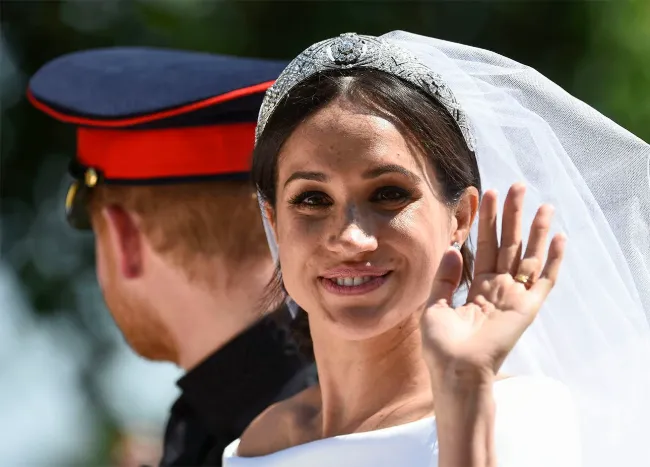 "Prince Harry and Meghan Markle leaving their wedding ceremony in a carriage"