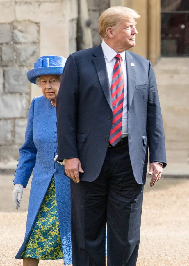 Donald Trump walking in front of Queen Elizabeth