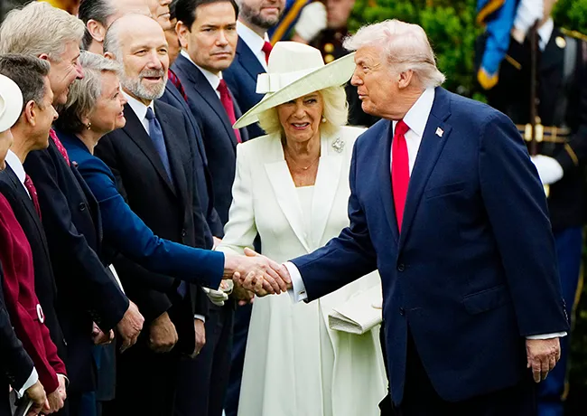 Donald Trump cutting in front of Queen Camilla shaking hands state visit